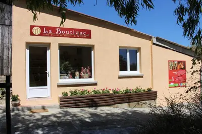 a store with a flower box in front of a building at Gites et Roulottes au Domaine de la Trille in Sainte-Foi