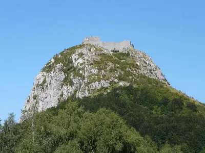 a castle on the top of a mountain at Gites et Roulottes au Domaine de la Trille in Sainte-Foi