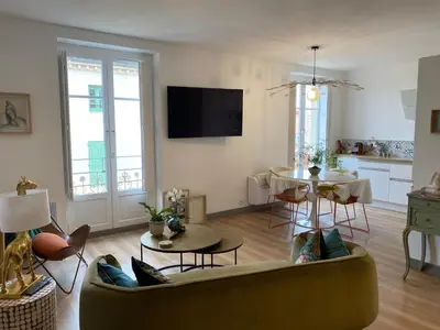a living room with a couch and a table at Coural' Chic in Narbonne