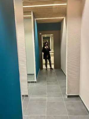 a woman taking a picture of herself in a bathroom mirror at Coural' Chic in Narbonne