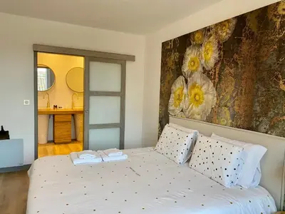 a bedroom with a bed with two towels on it at Coural' Chic in Narbonne