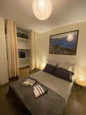 a bedroom with a large bed with two towels on it at La Rosela de la Cité in Palaja