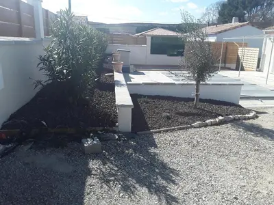 a garden with two trees in a yard at Maison individuelle neuve avec piscine in Limoux