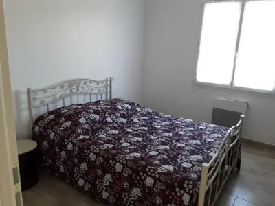 a bedroom with a bed with a blanket on it at Maison individuelle neuve avec piscine in Limoux
