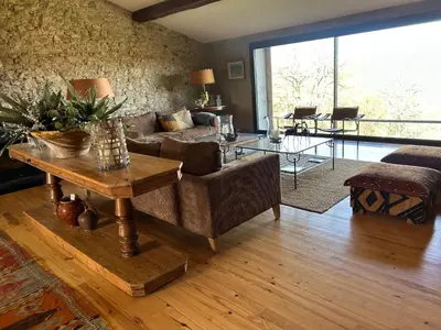 a living room with a couch and a table at Maison familiale de charme in Chalabre