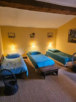 a hotel room with two beds and a table at Maison familiale de charme in Chalabre