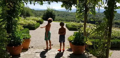 two young boys are standing in a garden at Maison familiale de charme in Chalabre