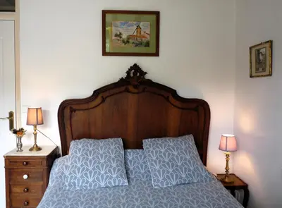 a bedroom with a bed with two night stands and two lamps at La Métairie de Lamourade, gîte nature in Saint-Ferriol