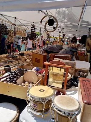 a market with drums and other items on display at La Métairie de Lamourade, gîte nature in Saint-Ferriol