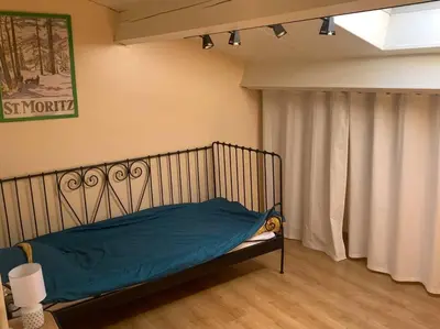 a bedroom with a bed with a blue blanket at Appartement mirepoix in Mirepoix