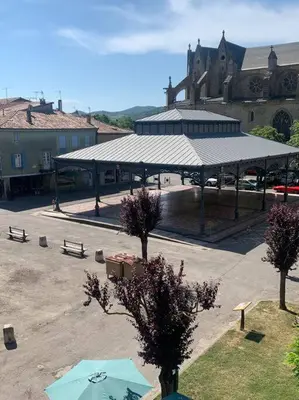 a pavilion with a roof in front of a building at Appartement mirepoix in Mirepoix