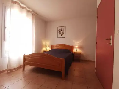 a bedroom with a bed and a window and two lamps at La trillano in Trilla