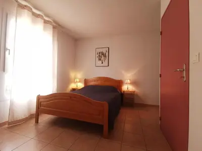 a bedroom with a wooden bed and a window at La trillano in Trilla