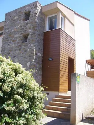 a house with a stone building with a door at La trillano in Trilla