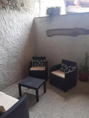 a patio with two chairs and a chair and a table at la maison des vendangeurs in Villesequelande