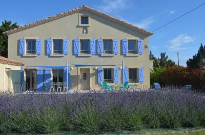 a house with purple flowers in front of it at Gîte Marin in Narbonne