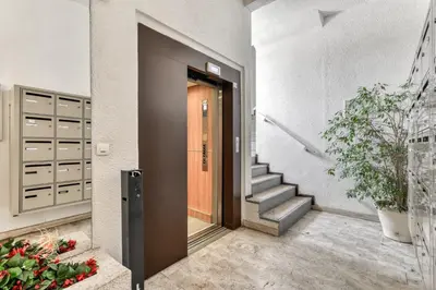 a hallway of a house with a door and stairs at Studio cabine Viktoria in Gruissan