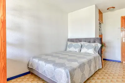 a bedroom with a bed in a room at Studio cabine Viktoria in Gruissan