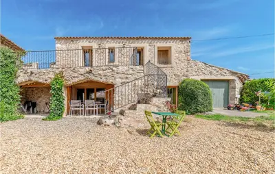 a stone house with a staircase in front of it at Awesome Home In Pardailhan With Kitchen in Pardailhan