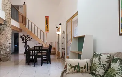 a living room with a couch and a table at Awesome Home In Pardailhan With Kitchen in Pardailhan