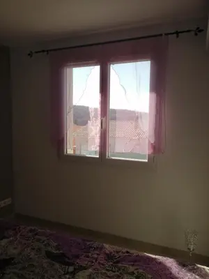 an empty room with a window with pink curtains at EVANA in Bize-Minervois