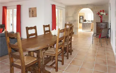 a dining room with a wooden table and chairs at Stunning Home In Ferrals Les Corbières in Ferrals-lès-Corbières