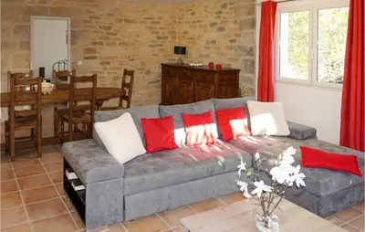 a living room with a gray couch with red and white pillows at Stunning Home In Ferrals Les Corbières in Ferrals-lès-Corbières