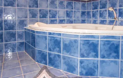 a blue tiled bathroom with a bath tub at Stunning Home In Ferrals Les Corbières in Ferrals-lès-Corbières