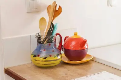 a colorful vase and a tea pot on a counter at Chez Shona in Lagrasse