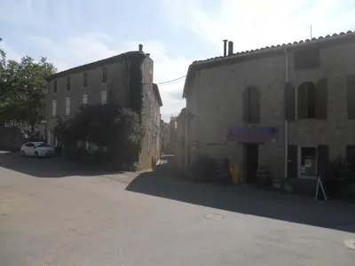 an old building with a car parked next to it at Chez Shona in Lagrasse