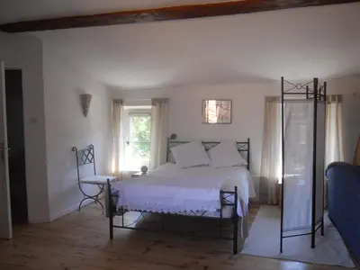 a bedroom with a white bed and a window at Chez Shona in Lagrasse