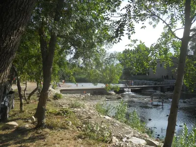 a bridge over a river with people walking on it at Chez Shona in Lagrasse