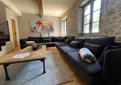 a living room with a couch and a coffee table at La Maison de La Tour Pinte in Carcassonne