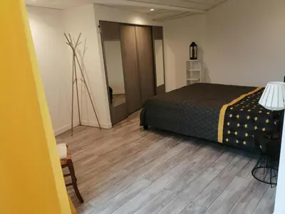a bedroom with a bed and a wooden floor at Horizon Caramany : un havre de douceur, vue lac ! in Caramany