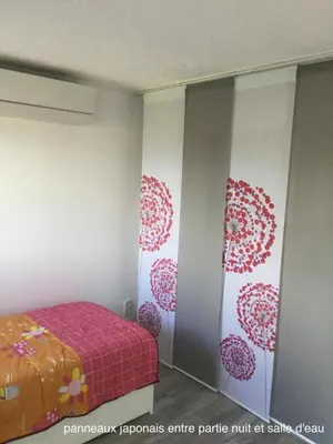 a bedroom with a bed with a pink blanket at Horizon Caramany : un havre de douceur, vue lac ! in Caramany