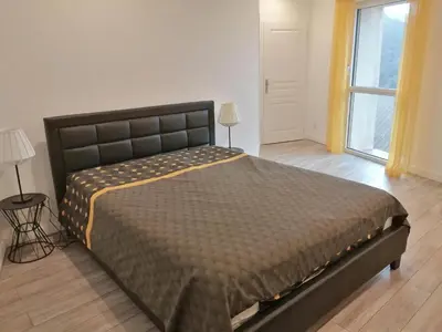 a large bed in a room with a window at Horizon Caramany : un havre de douceur, vue lac ! in Caramany