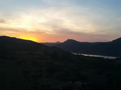 a sunset over a valley with a river and mountains at Horizon Caramany : un havre de douceur, vue lac ! in Caramany