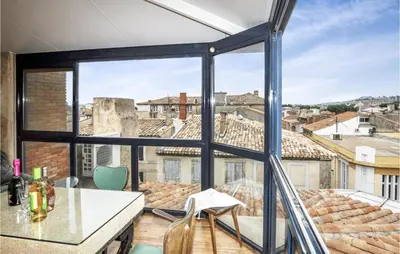 a room with a large window with a table and chairs at 2 Bedroom Gorgeous Home In Carcassonne in Carcassonne