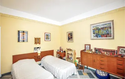 a bedroom with two beds and a dresser at 2 Bedroom Gorgeous Home In Carcassonne in Carcassonne