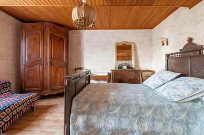 a bedroom with a bed and a dresser in a room at Maison accueillante avec jardin à Albas in Albas