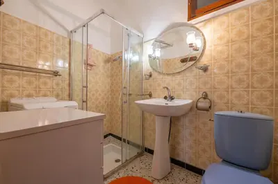 a bathroom with a toilet and a sink and a shower at Maison accueillante avec jardin à Albas in Albas