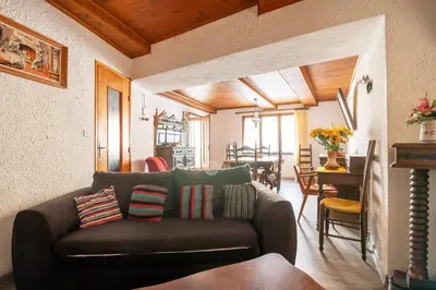 a living room with a couch and a dining room at Maison accueillante avec jardin à Albas in Albas