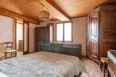 a bedroom with a bed and a wooden ceiling at Maison accueillante avec jardin à Albas in Albas
