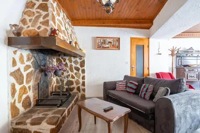 a living room with a couch and a stone wall at Maison accueillante avec jardin à Albas in Albas