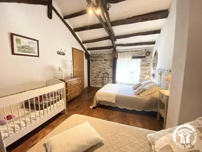 a bedroom with two beds and a crib at Dame nature in La Tourette-Cabardès