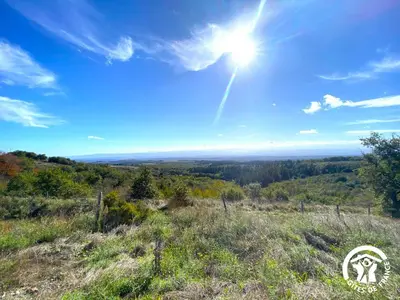 a view from the top of a hill with the sun in the sky at Dame nature in La Tourette-Cabardès