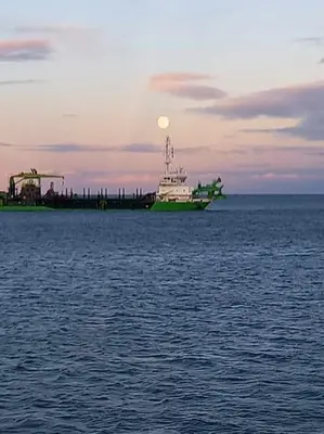 a large boat in the ocean with a sunset at Pavillon in Port-la-Nouvelle