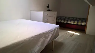 a bedroom with a white bed and a dresser and a bed sqor at Pavillon in Port-la-Nouvelle