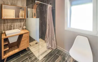 a bathroom with a shower and a desk and a chair at Cozy Home In Saint-Jean-De-Minervoi in Saint-Jean-de-Minervois