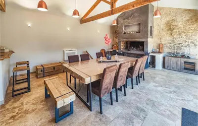 a dining room with a large wooden table and chairs at Cozy Home In Saint-Jean-De-Minervoi in Saint-Jean-de-Minervois